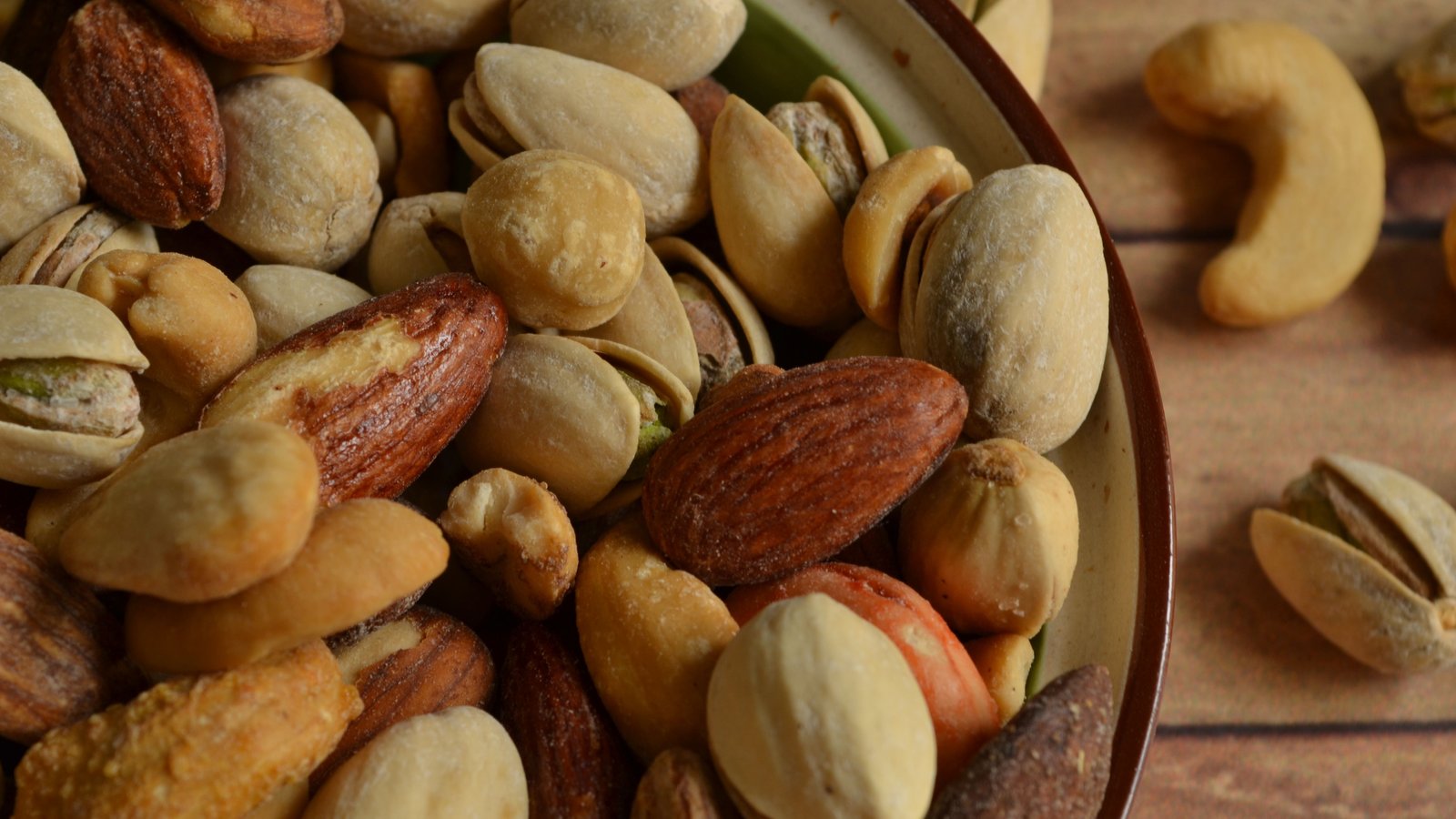 A bowl of mixed nuts including almonds, pistachios, and cashews, typical of an Arabic grocery