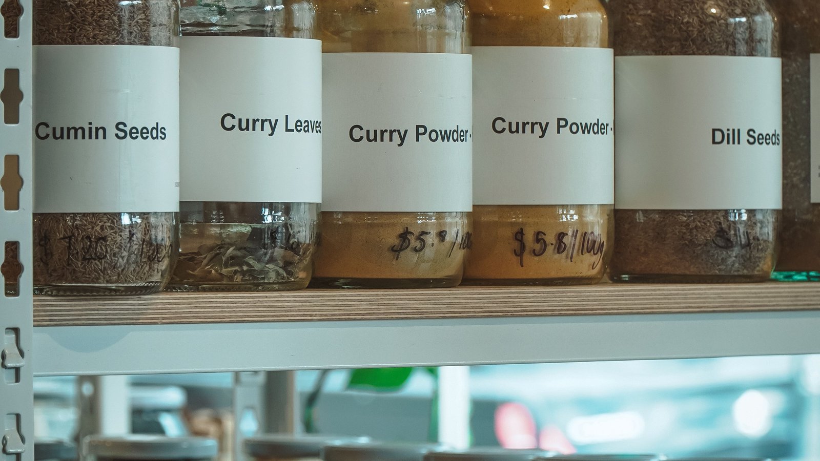 Shelves of labelled spice jars typical of an Arabic grocery store in Ampang