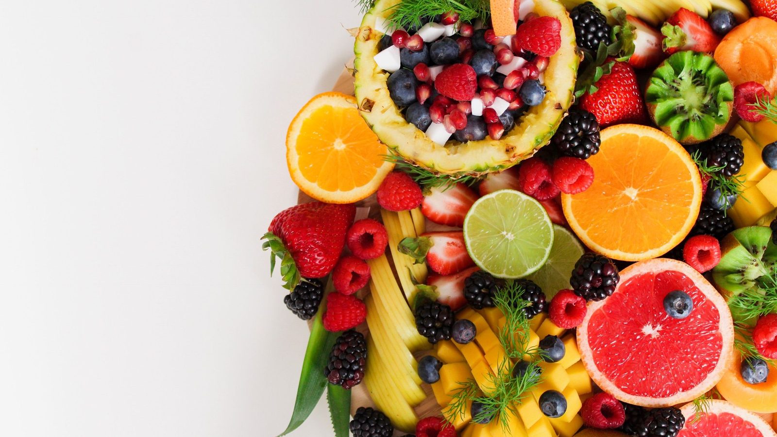 Colourful fruit flat-lay representing the five Sihatree Arabic Gum flavours