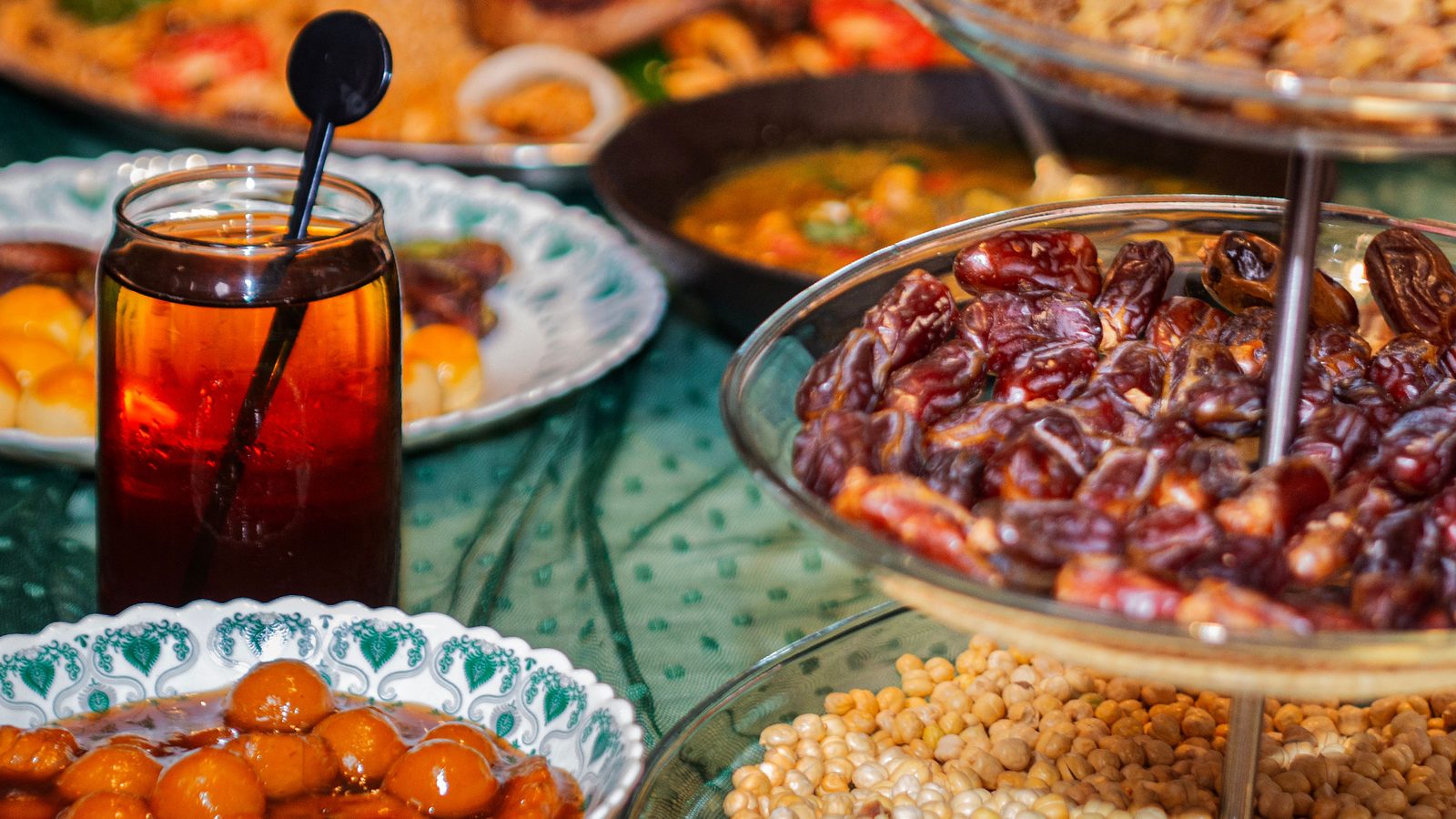 Traditional Ramadan iftar table spread with a bowl of dates, tea, and side dishes