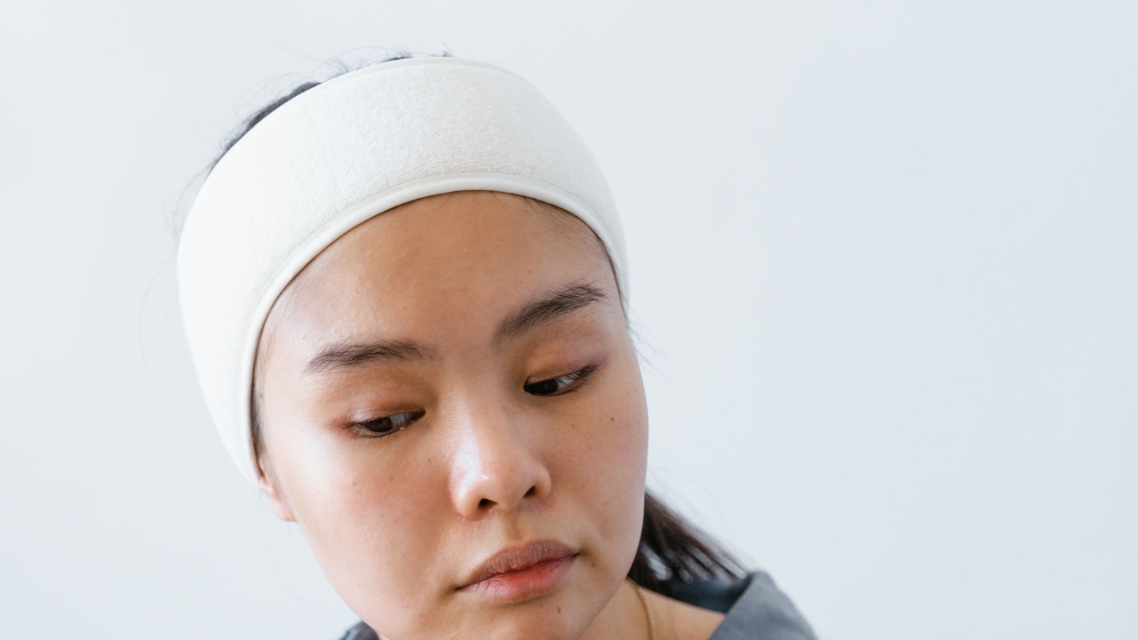 Close-up portrait of a woman with clear, radiant skin during a skincare routine