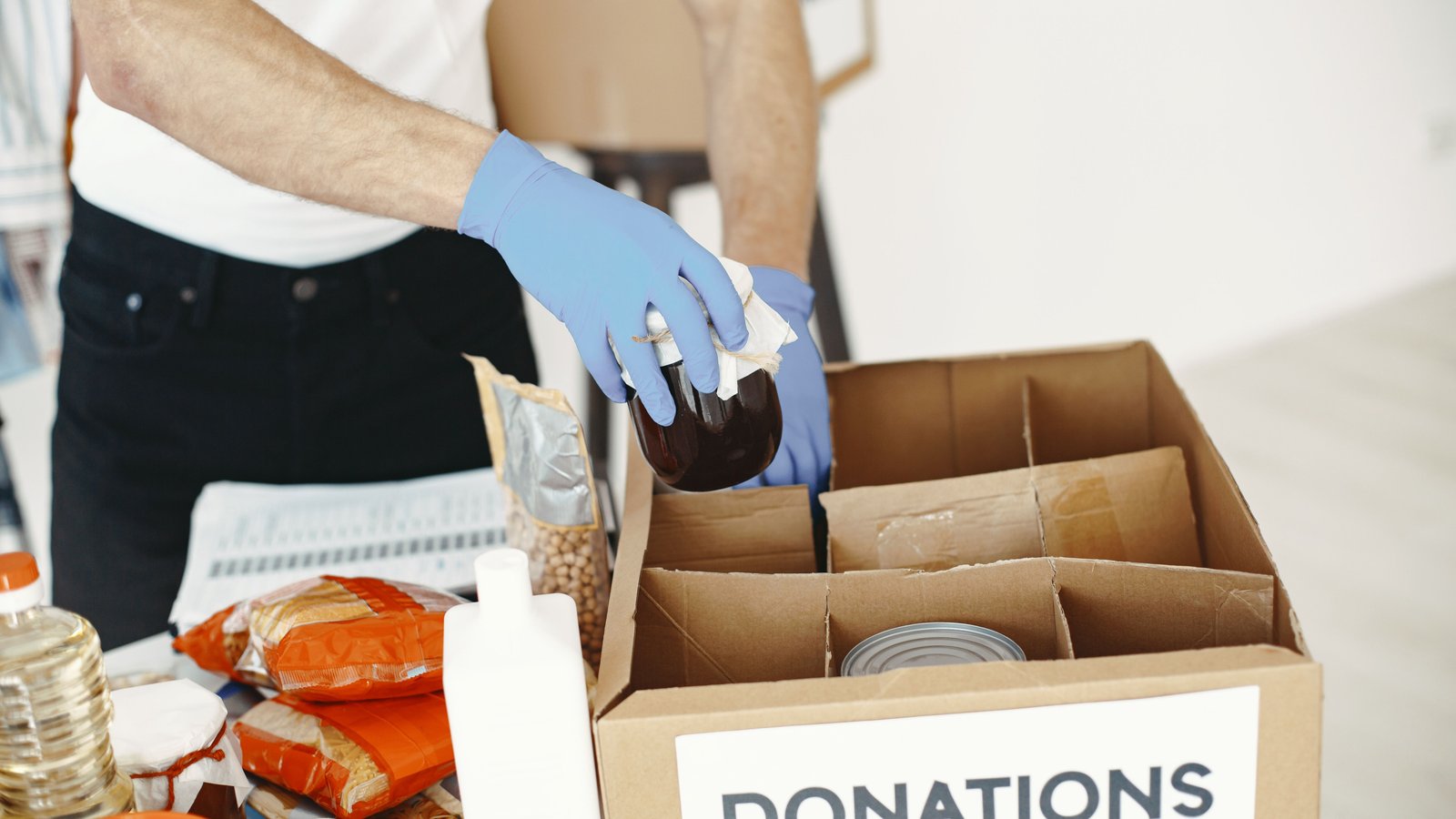 Food donation box being packed, representing Berkat Madinah Store's charitable work
